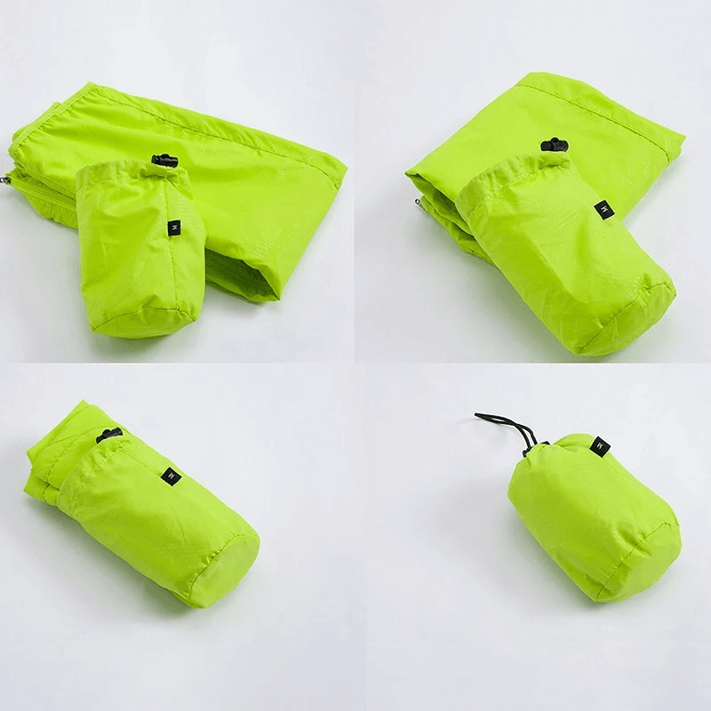 Compact waterproof polyester hiking jacket in vibrant green, folded and packed, showcasing its lightweight and portable design.